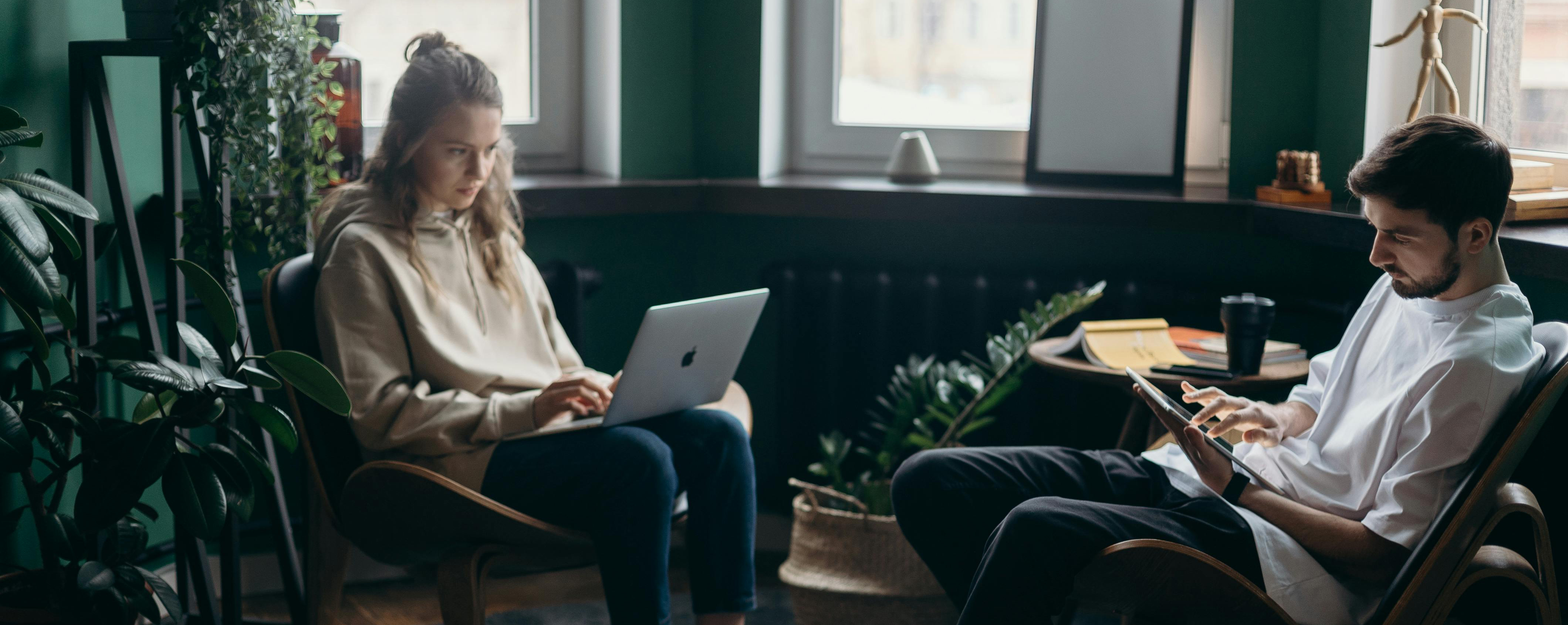 Two people working from a home office setup.